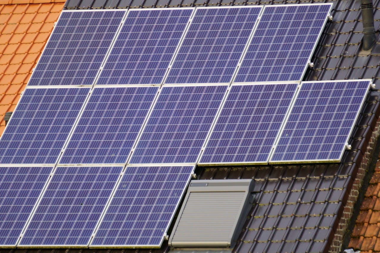 Close-up view of solar panels on a tiled rooftop, capturing clean energy.